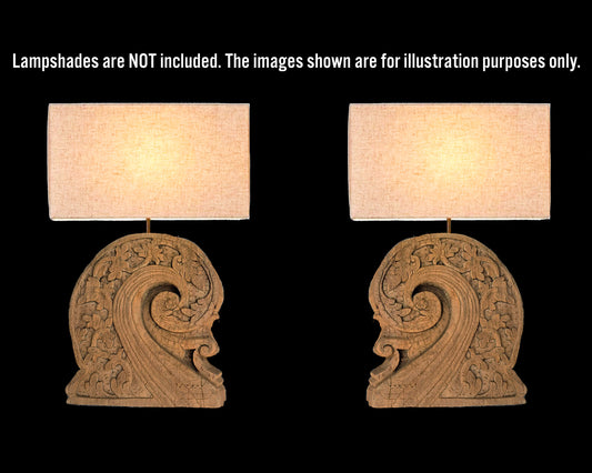 Two ornate wooden lamps with beige lampshades on a black background.