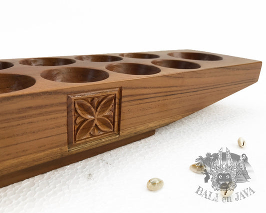 Wooden mancala board game on a white board game