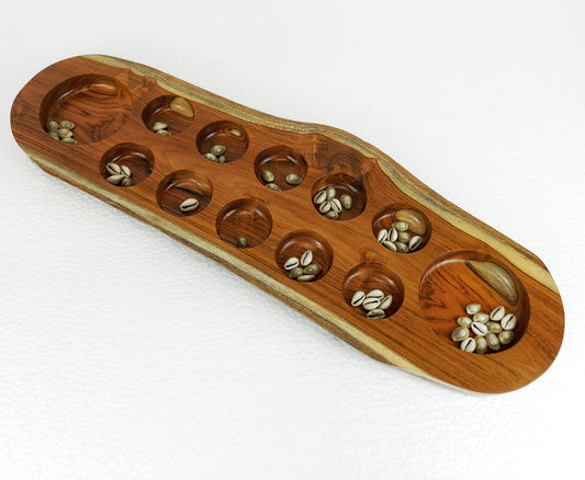 Mancala board game made of tropical hardwood or teak wood with shells for gameplay, handmade by artisans in Asia
