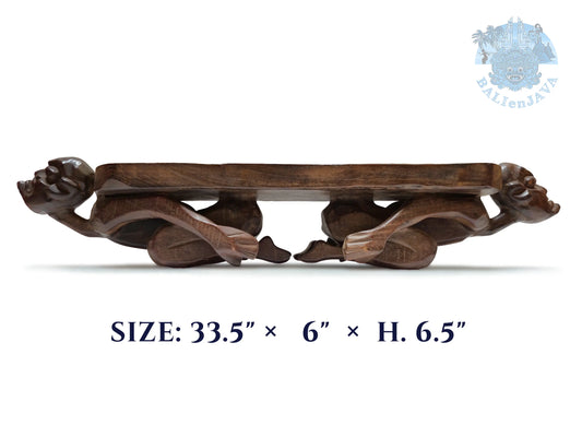A dark brown carved wooden board game with two sculpted human figures supporting the sides, shown on a white background with measurements information below.