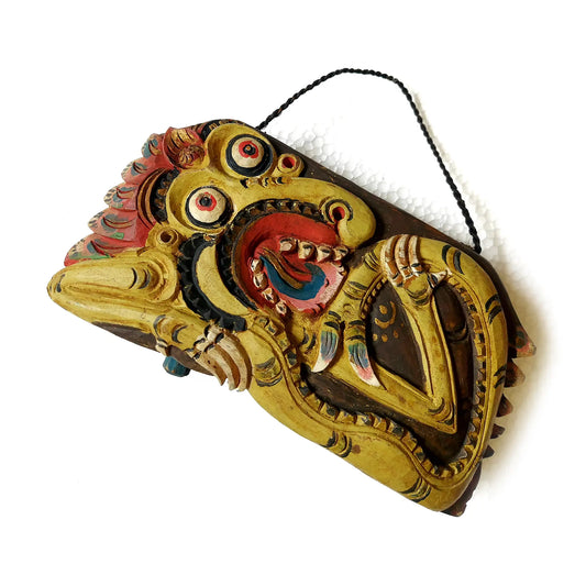 A hand-carved wooden bell with a curved bottom, featuring a mythological dragon in red and gold tones, set against a plain white background.