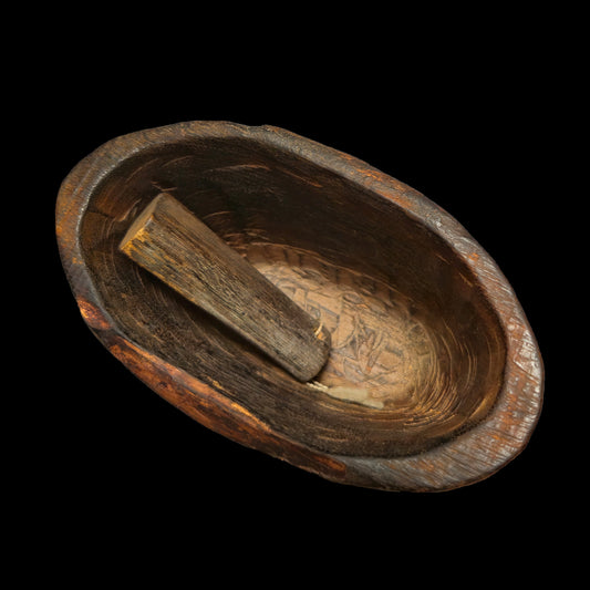 Wooden bell lip and clapper on a black background.