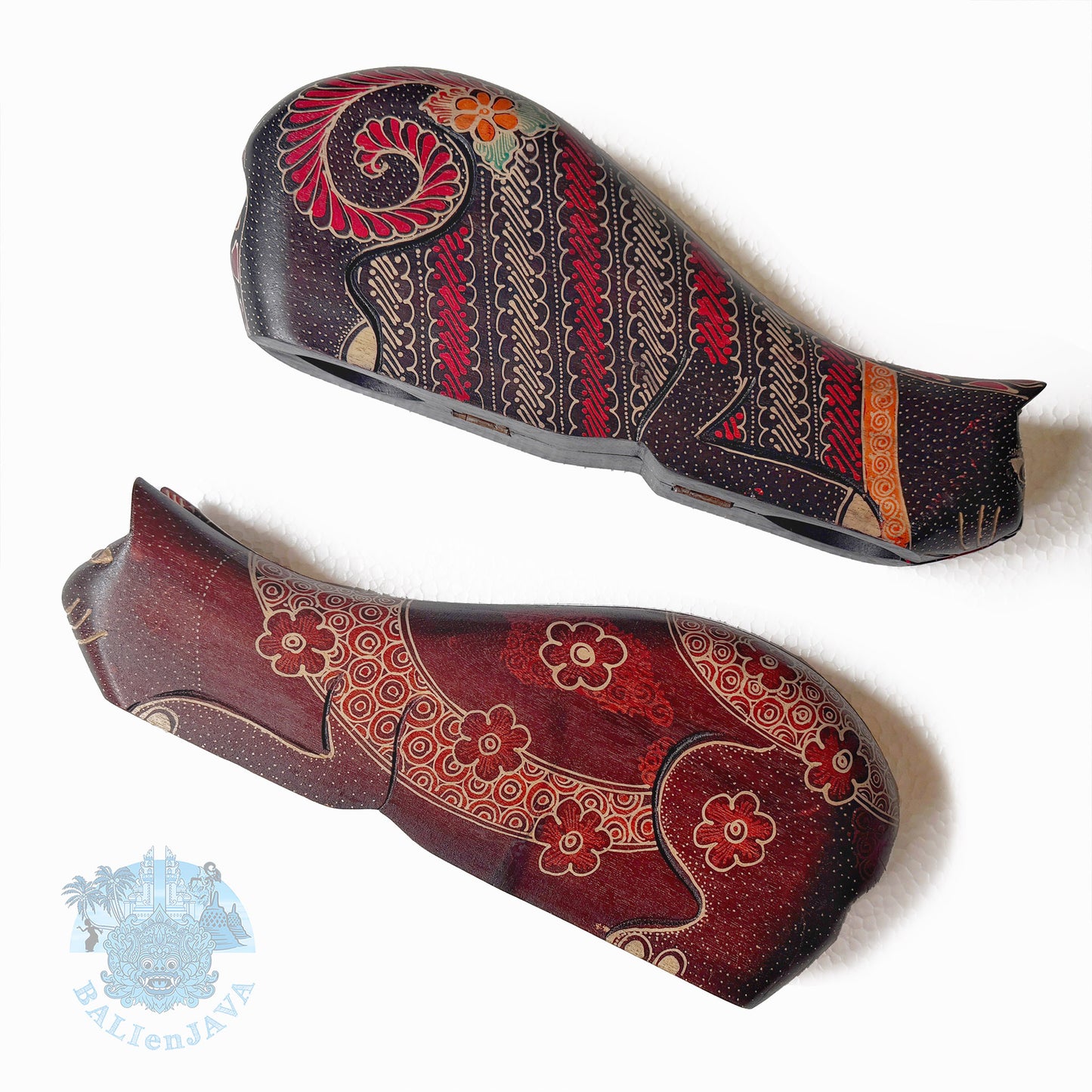 Two decorative cat-shaped wooden toys with intricate patterns on a white background