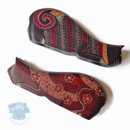 Two decorative cat-shaped wooden toys with intricate patterns on a white background