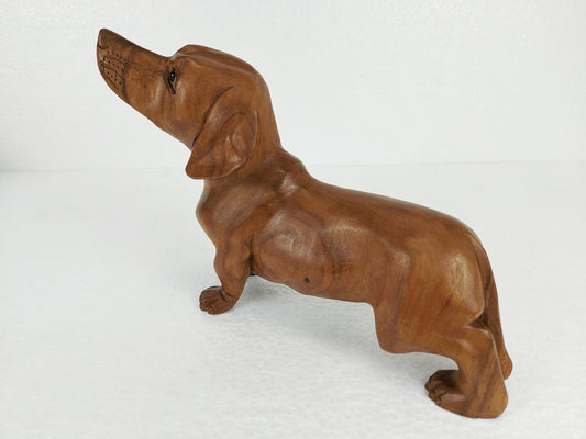 Wooden hand-carved statue of a dachshund dog. 