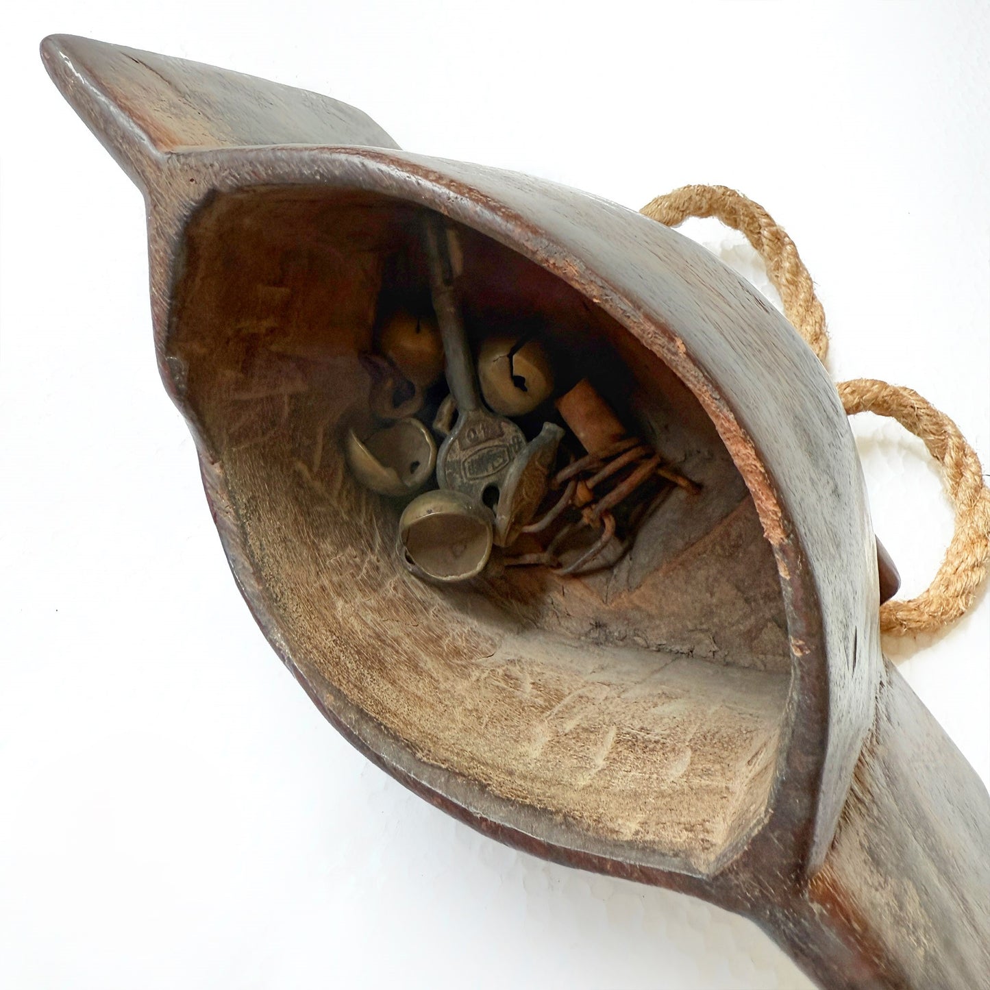 Wooden bell with small metal jingles inside on a white background