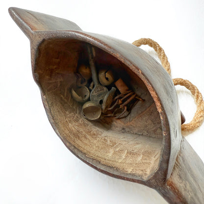Wooden bell with small metal jingles inside on a white background