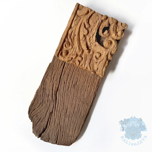 A carved wooden decorative piece with an  carved light brown top section and a weathered dark brown lower section, shown on a plain white background .