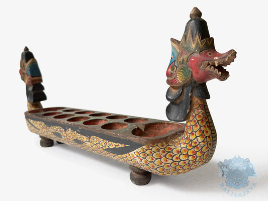 Decorative dragon-shaped mancala game with colorful details on a white background