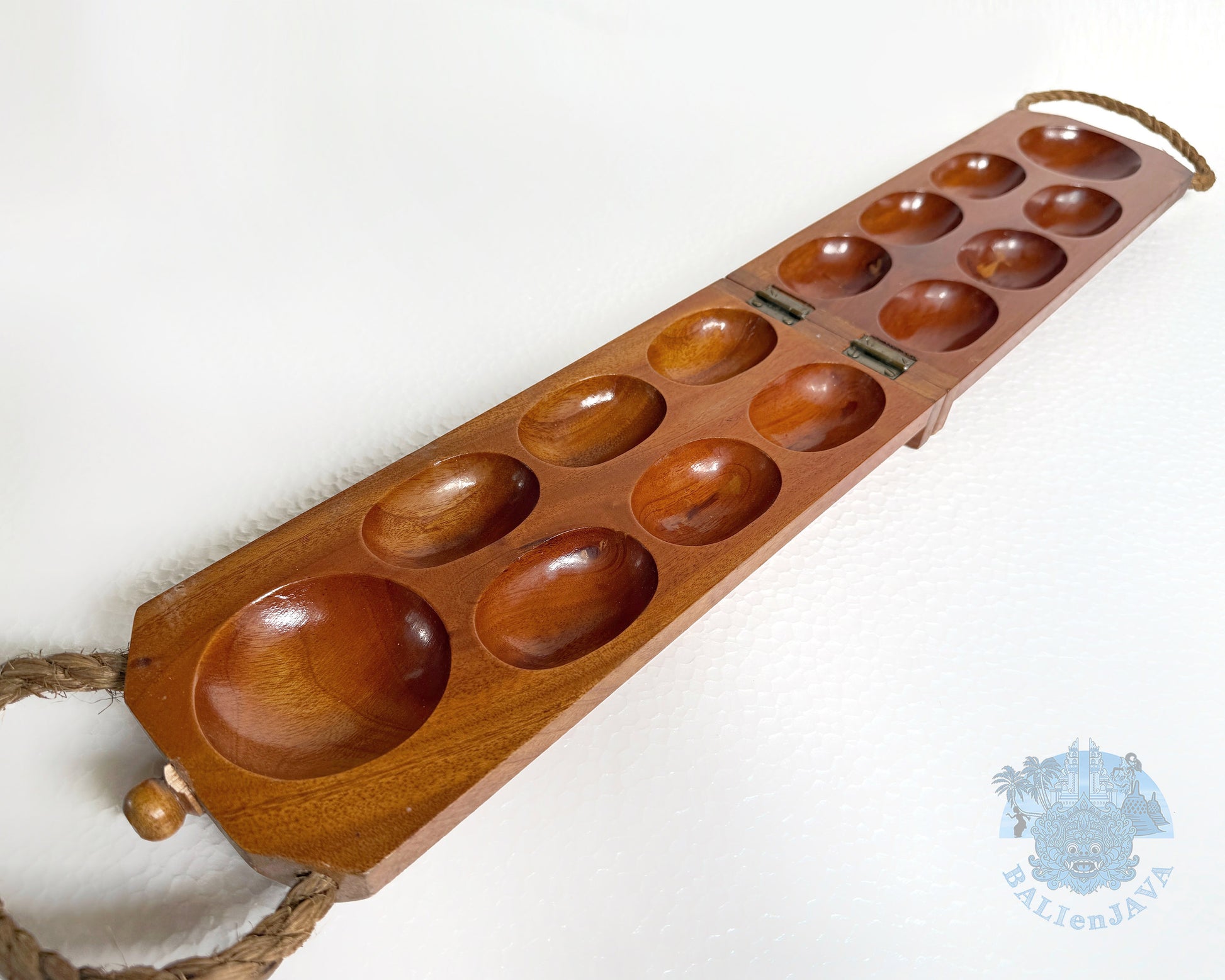 Wooden Mancala board on a white background