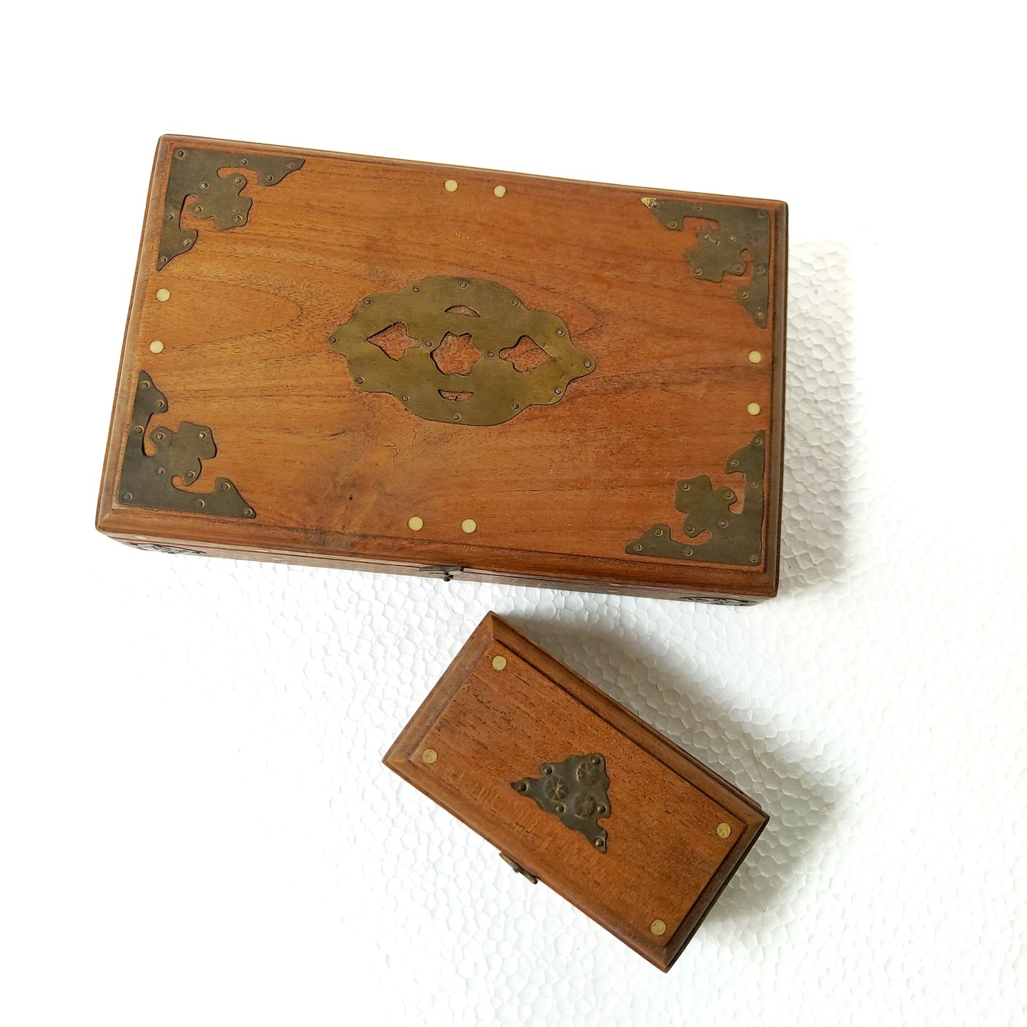 Two wooden boxes with decorative oriental brass accents. 