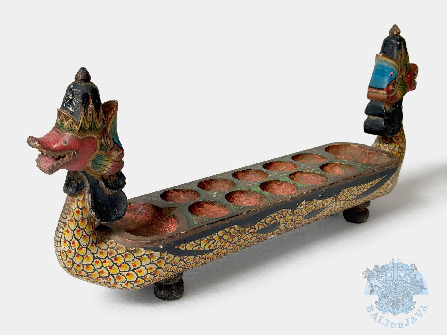 Decorative dragon-shaped board game with colorful details on a white background