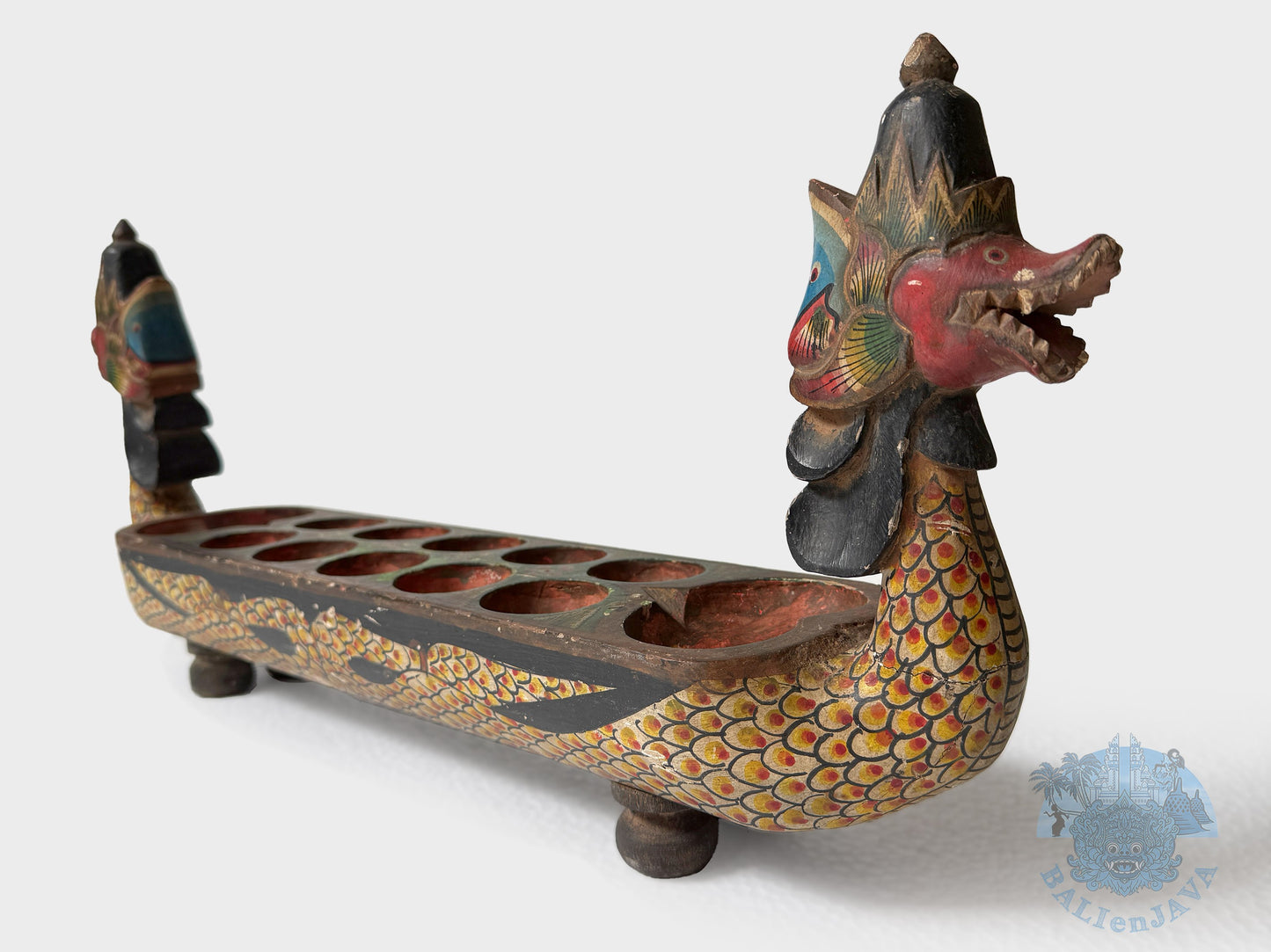 Decorative dragon-shaped board game with colorful details on a white background
