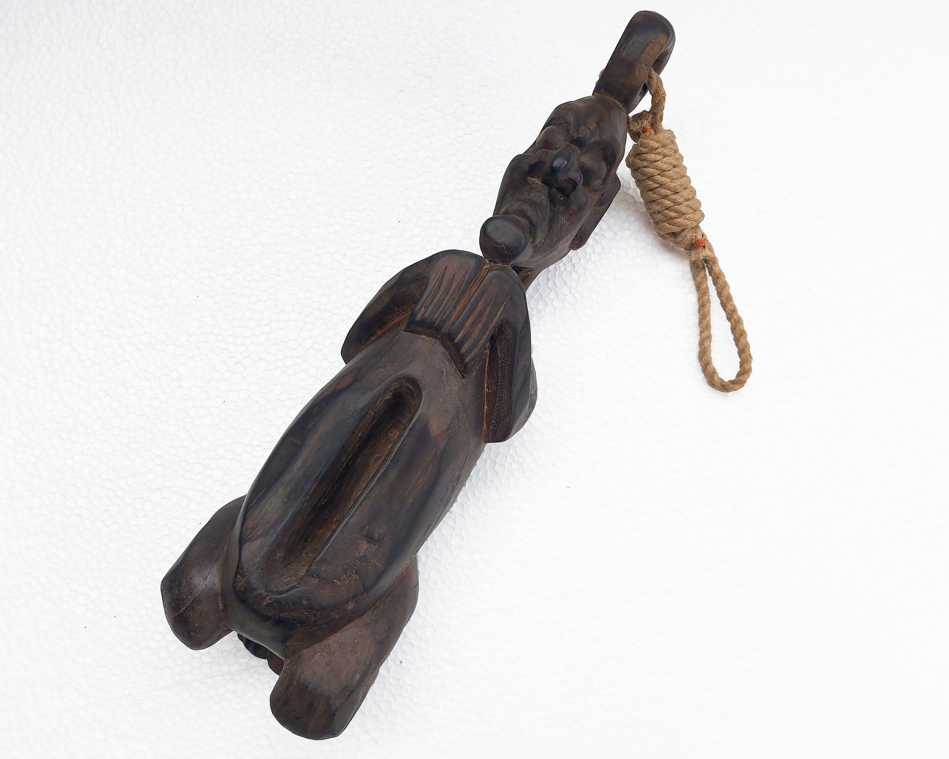 Wooden figure with a rope on a white background