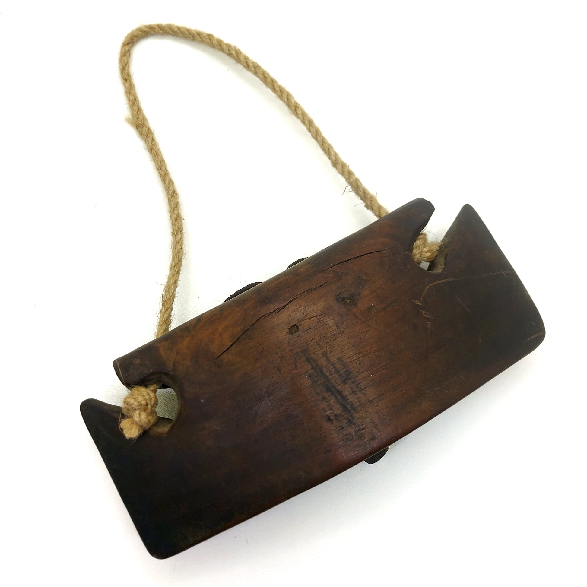 Vintage dark wooden cattle bell with rope handle