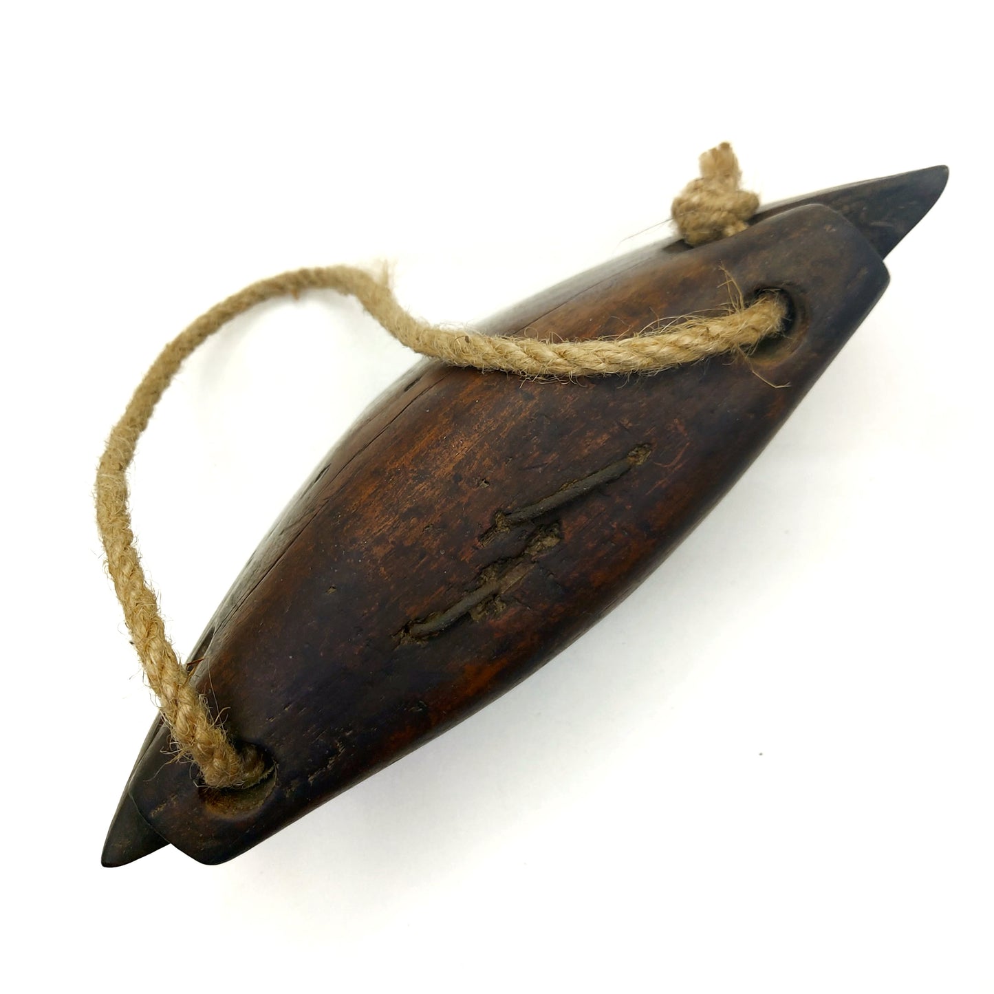 Top view of a wooden bell with a rope handle