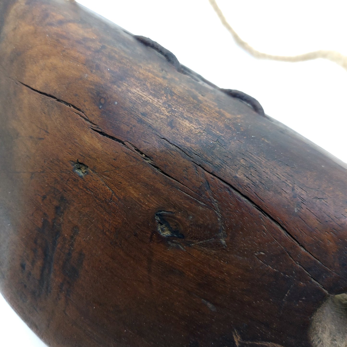 Weathered surface of an old wooden bell with small fine cracked lines