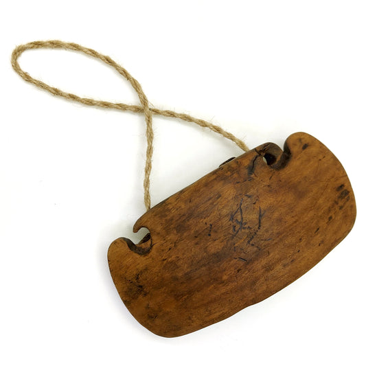 Old wooden cattle bell with rope handle on a white background