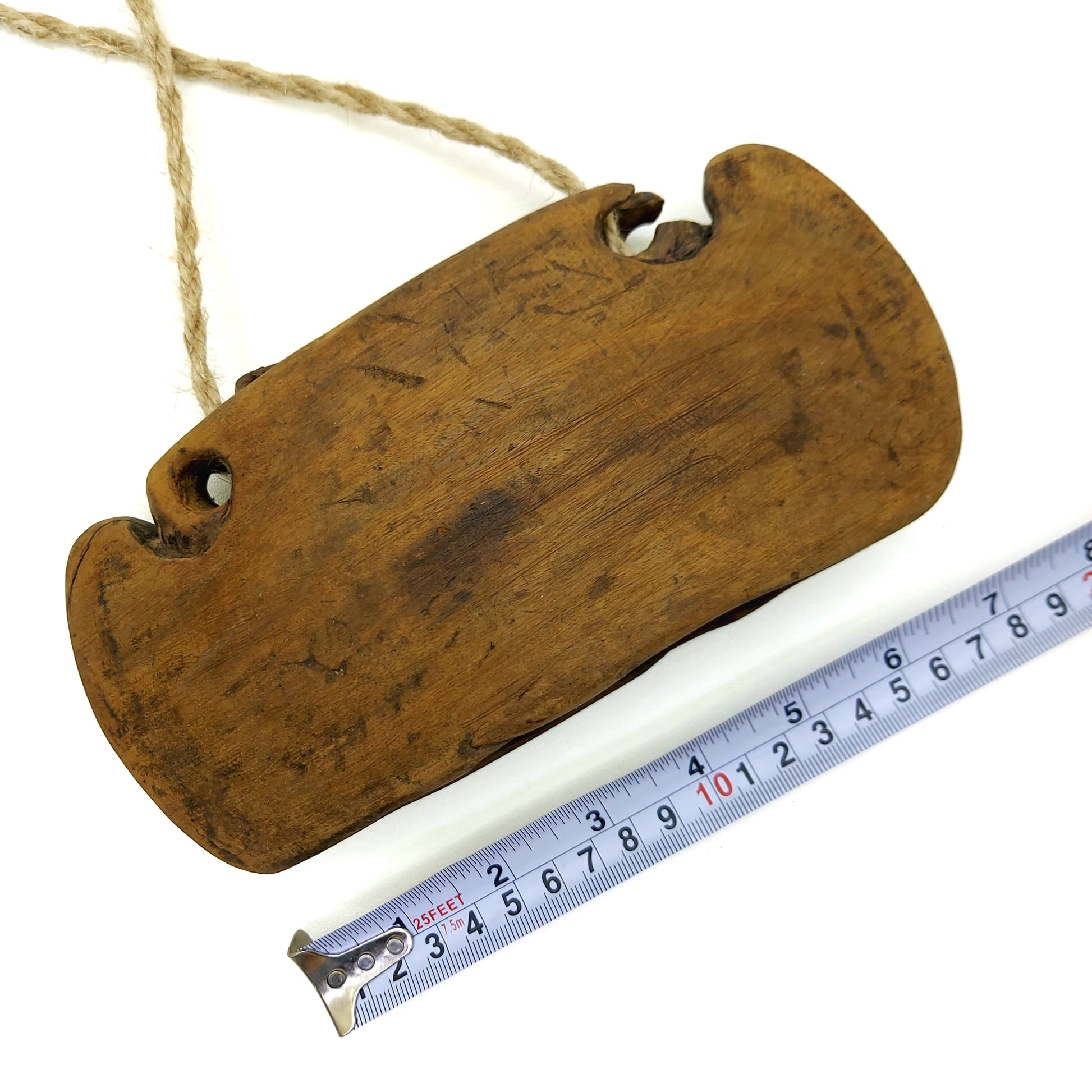 Wooden bell with measurements on a white background