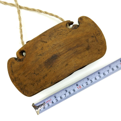 Wooden bell with measurements on a white background
