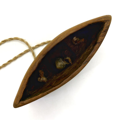 Bottom part of a wooden bell with the metal clappers visible