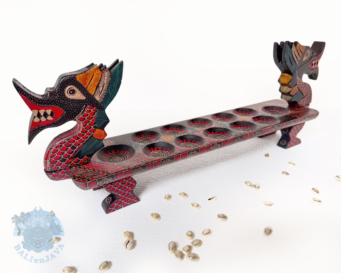 Mancala board game resembling a dragon with a long, narrow body and two heads on a white background.
