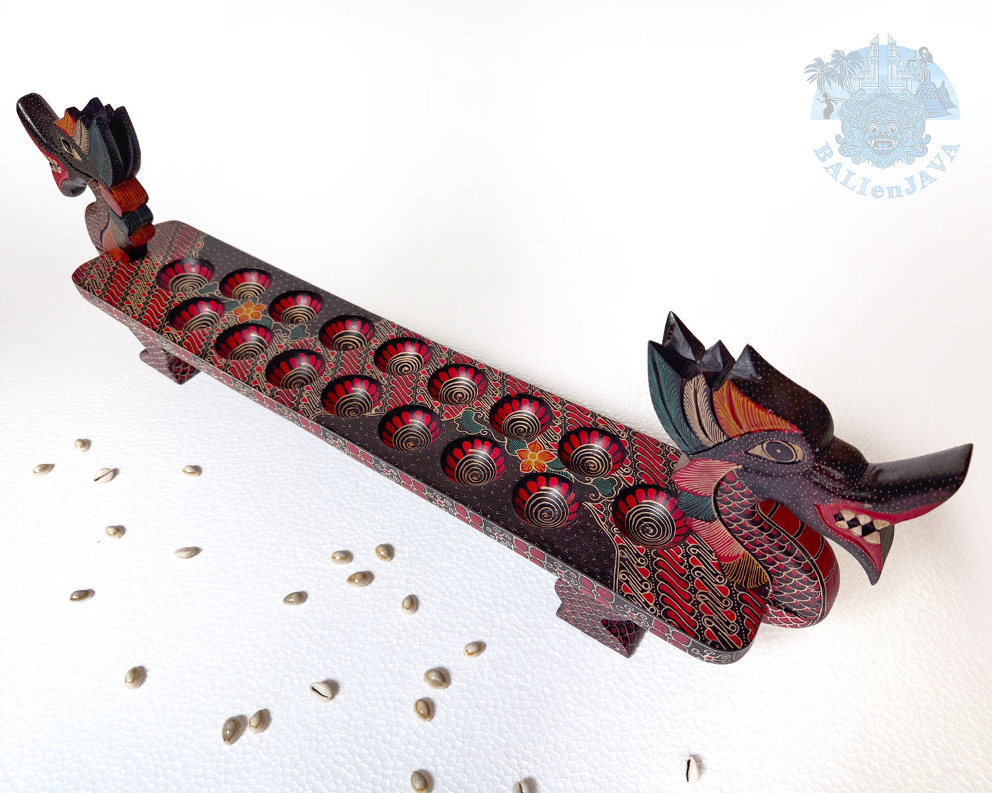 Decorative wooden dragon sculpture with red accents on a white background