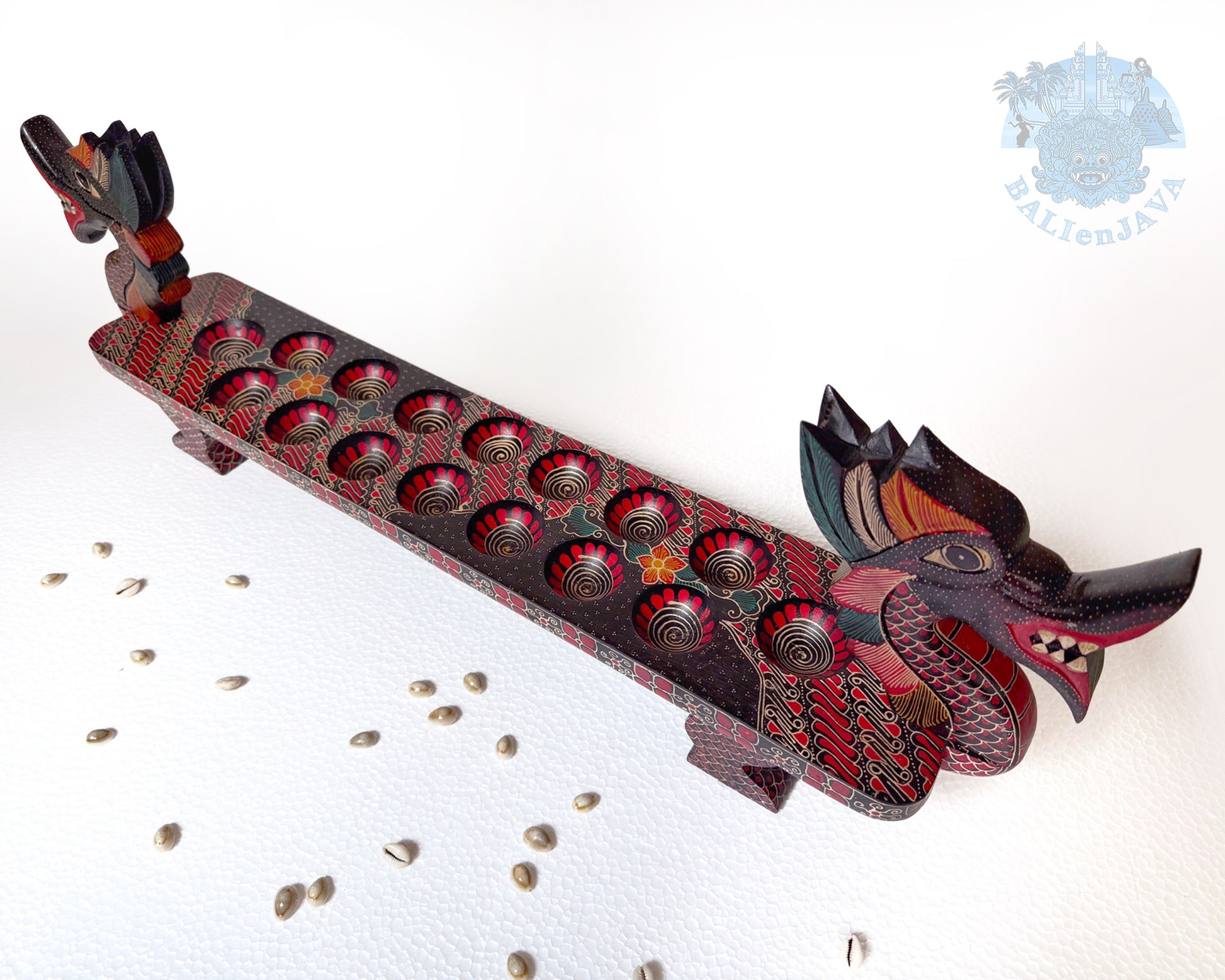 Decorative wooden dragon sculpture with red accents on a white background