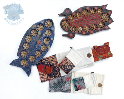A set of traditional handmade wooden mancala game, and several folded fabric pouches, displayed on a white background.