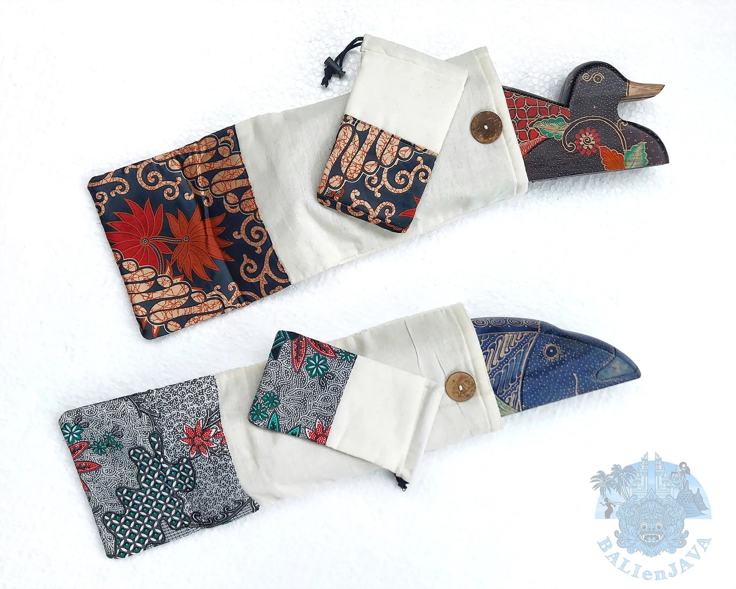 Two handmade mancala game inside  fabric pouches with patterned cuffs and wooden buttons, displayed on a white background.