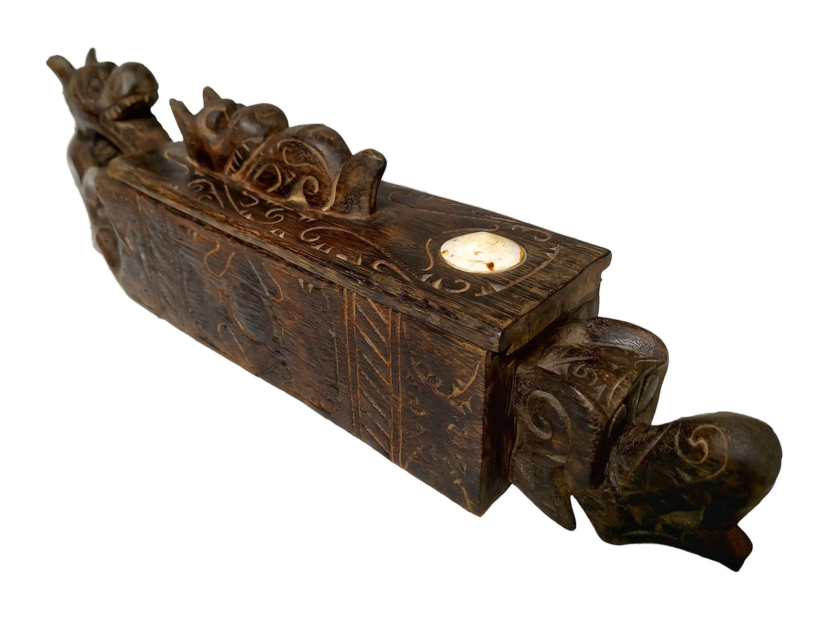 A dark brown carved dragon wooden box with handle, shown against a plain white background.