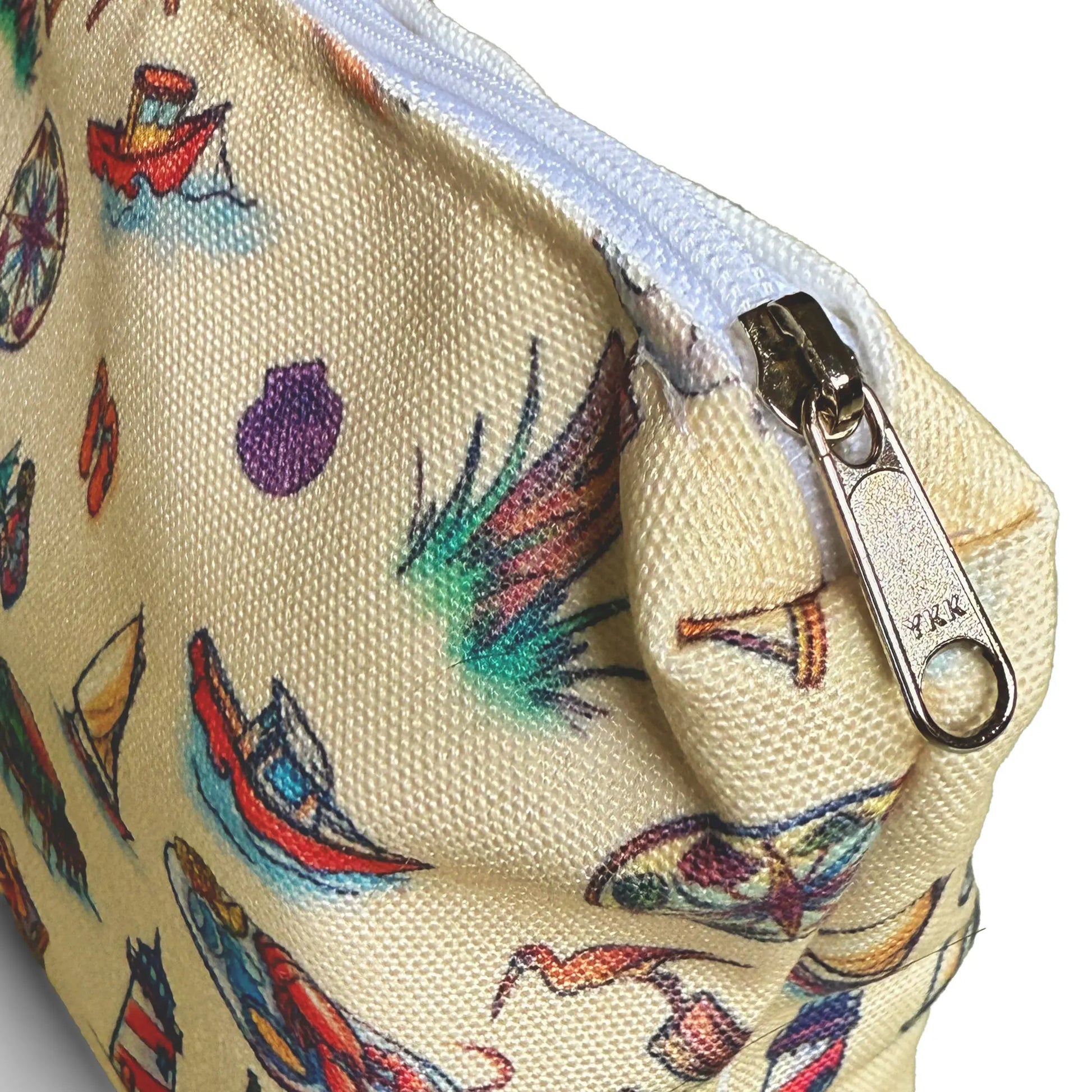 Small pouch with colorful coastal pattern and zipper on a white background