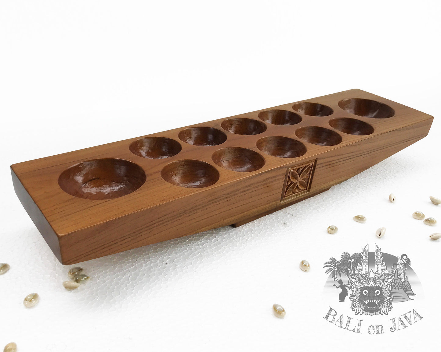 Wooden mancala board game with holes on a white background
