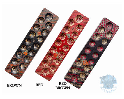 Three mancala board games with hand-painted design and seven circular pits labeled Brown, Red, and Red Brown on a white background