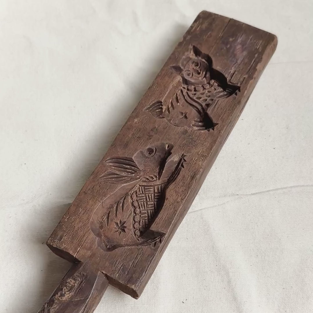 Double-sided cookie mold with different design on a white background