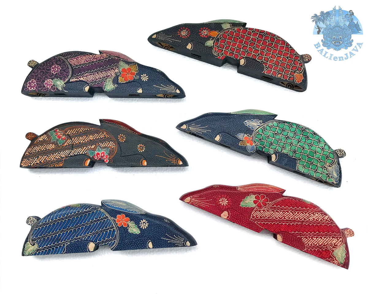 Six handcrafted rabbit-shaped wooden mancala board games with intricate hand-painted patterns in red, green, purple, blue, brown and black, arranged on a white background.