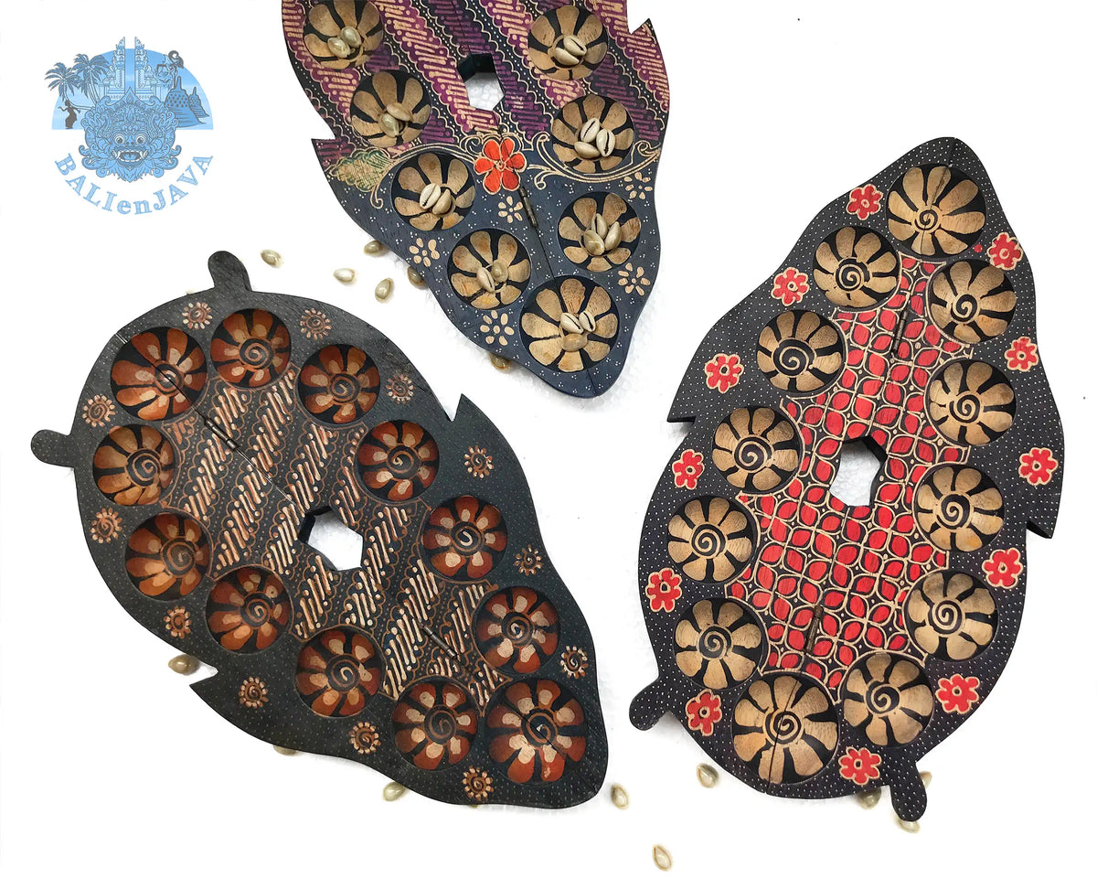Three handcrafted board games with circular pits, intricate floral and geometric patterns, displayed on a clean white background.
