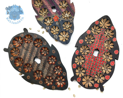 Three handcrafted board games with circular pits, intricate floral and geometric patterns, displayed on a clean white background.