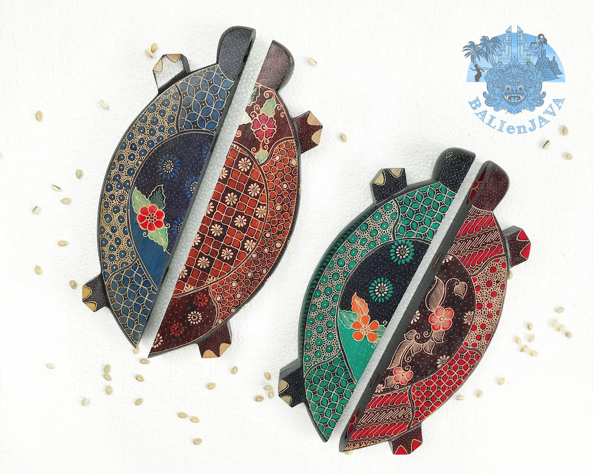Four turtle-shaped mancala board game in blue, green. brown and red colors on a white background in folding position with cowrie shells scattered nearby.