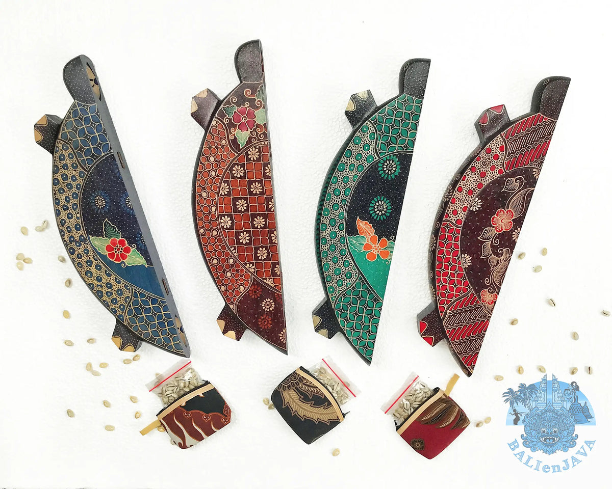 Four turtle-shaped mancala board game on a white background in folding position, including three small coin purse at the bottom, with cowrie shells scattered nearby.