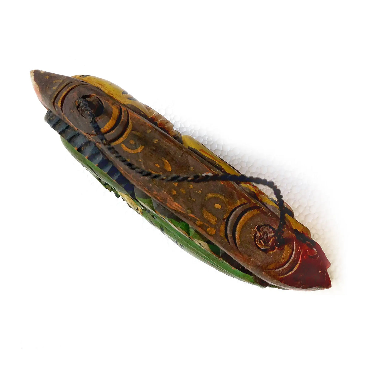 Top part of a wooden bell painted in brown, gold, green, and red tones, featuring a black hanging cord, shown on a white background.