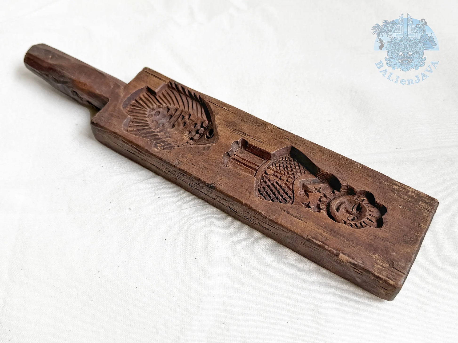 Wooden mold with a fish and a woman design on a white background