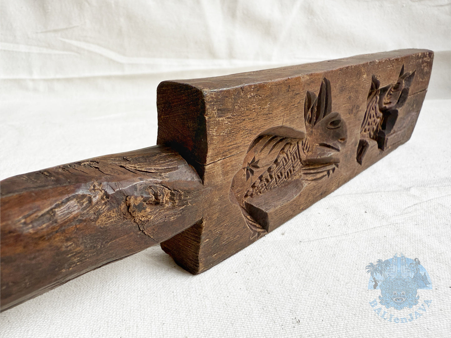 Wooden cookie mold with animal motifs on a white background