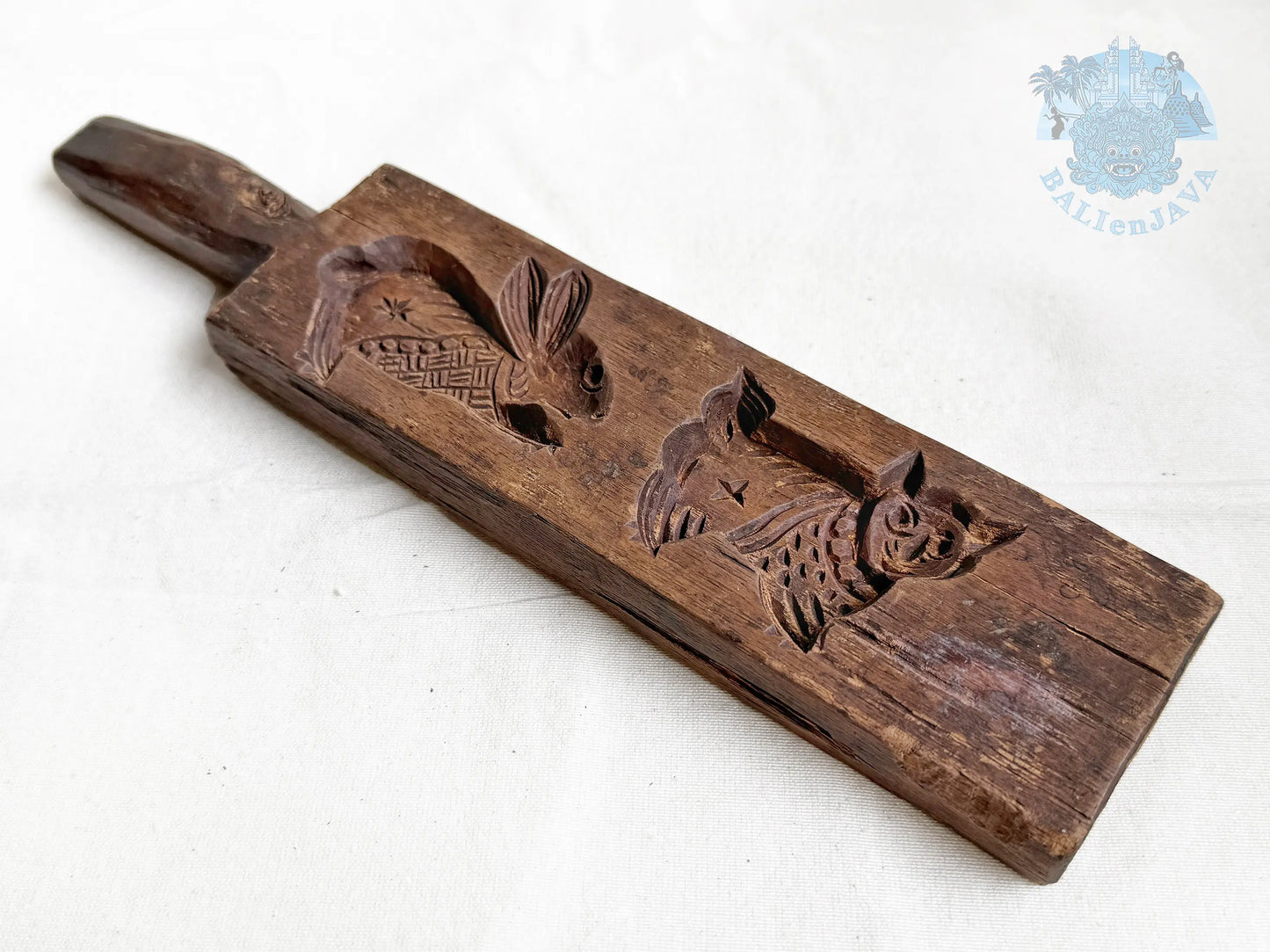 Wooden cookie mold with rabbit and cat designs on a white background