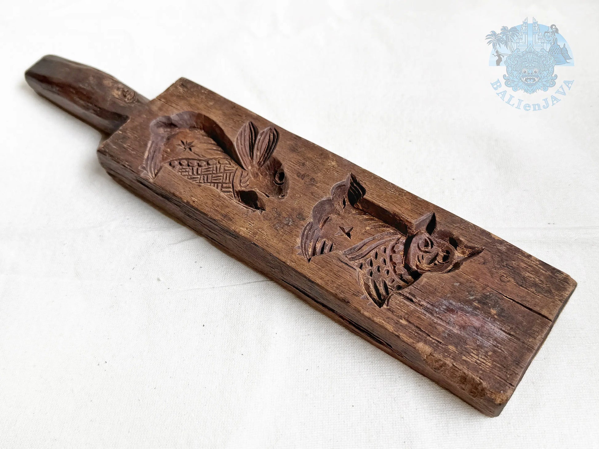 Wooden cookie mold with rabbit and cat designs on a white background