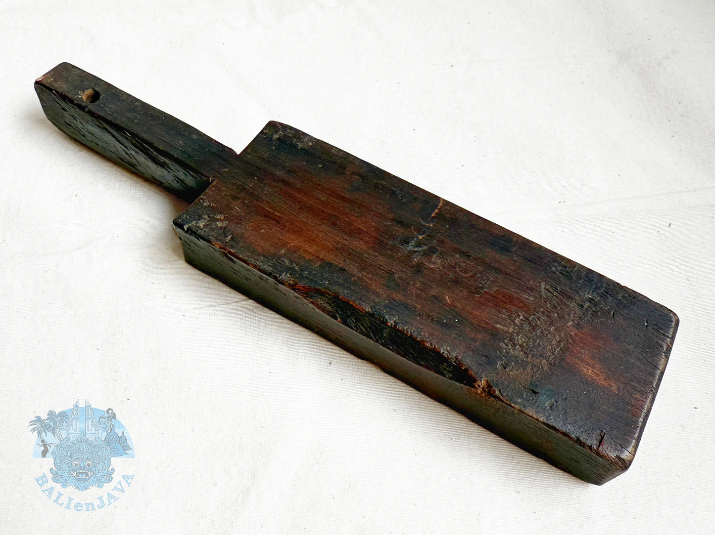 Wooden cookie mold with a handle on a white background