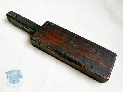 Wooden cookie mold with a handle on a white background